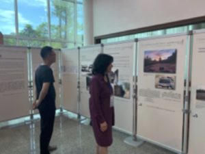 Conference participants looking at photographic/historical exhibit by photographer Li Ju