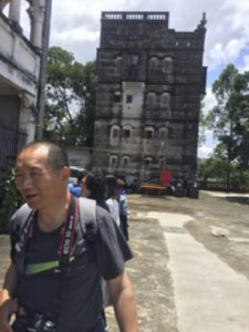 The Dialou, or watchtower, in Cangdong Village. Photographer Li Ju is in the foreground.