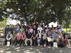 Conference participants and villagers gather for a group photo under Cangdong’s banyan tree.